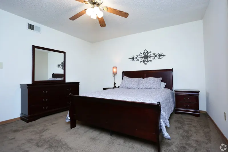 Furnished bedroom with a queen bed and dresser