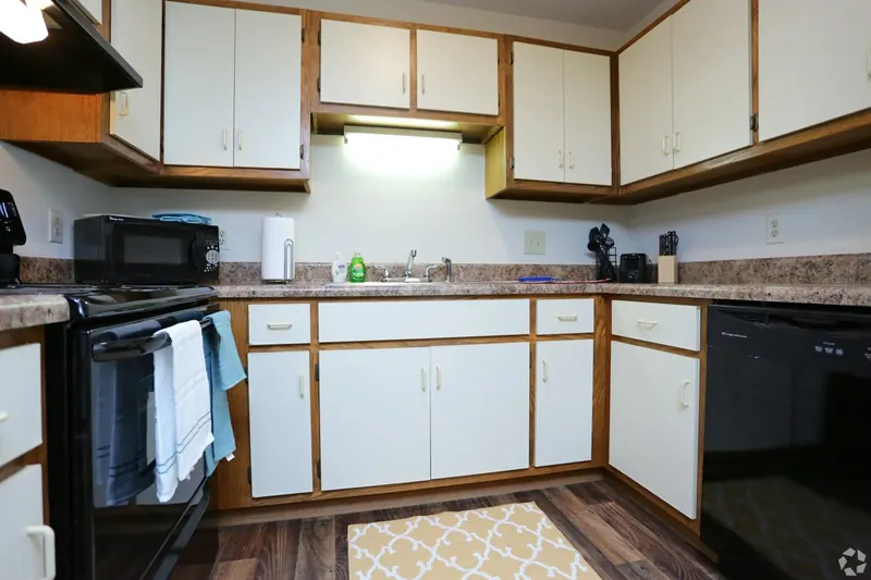 Kitchen with white cabinets and black appliances