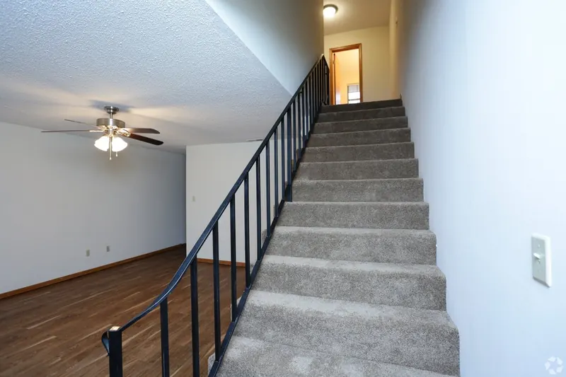 Carpeted staircase in a townhouse-style apartment